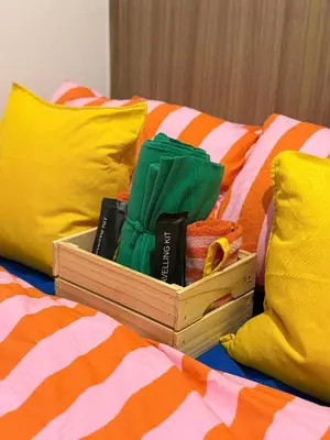 a box on top of a bed with colorful pillows at Euphoria Suites Shore 2 Tower 1 Residences in Manila