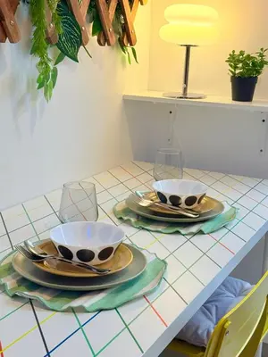 a table with two cups and plates on it at Euphoria Suites Shore 2 Tower 1 Residences in Manila