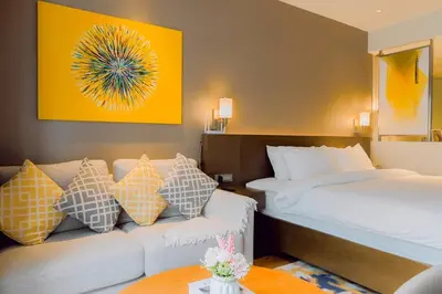 a hotel room with a bed and a couch at Primo Espacio at Hotel Residences Acqua in Manila