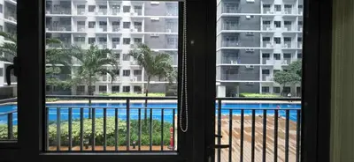 a view of a pool from a hotel room window at Near Airport Malls shore 3 Mall of Asia in Manila