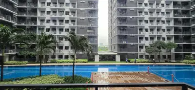 a view of two apartment buildings and a swimming pool at Near Airport Malls shore 3 Mall of Asia in Manila