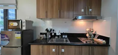 a kitchen with a sink and a refrigerator at Near Airport Malls shore 3 Mall of Asia in Manila