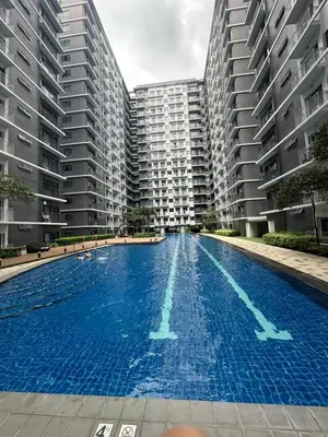 a large swimming pool in front of tall buildings at Near Airport Malls shore 3 Mall of Asia in Manila