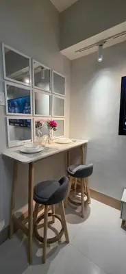 a kitchen with a table with two stools and a counter at Near Airport Malls shore 3 Mall of Asia in Manila