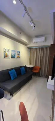 a living room with a black couch and chairs at Near Airport Malls shore 3 Mall of Asia in Manila