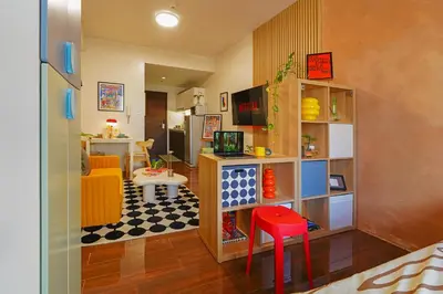 a living room with a lego room with a table and a kitchen at Airhaus Studio in Manila