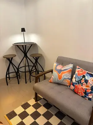 a living room with a couch and a table at Katya Suite in Pasong Bayog