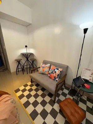 a living room with a chair and a table at Katya Suite in Pasong Bayog