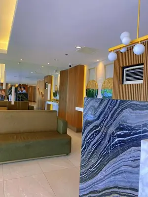 a room with a couch and a painting on the wall at Katya Suite in Pasong Bayog