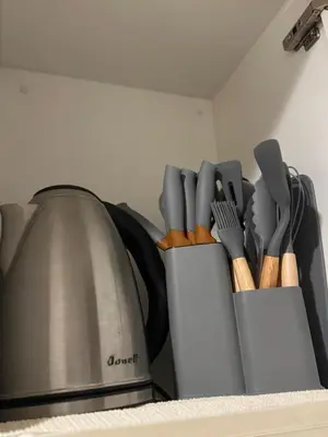 a knife block filled with utensils next to a stove at Modern 1BR One Uptown Residence Walk to UptownMall in Manila