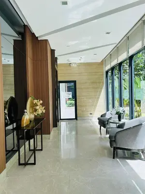 a lobby with chairs and tables and windows at Casa Bella Retreat in Manila