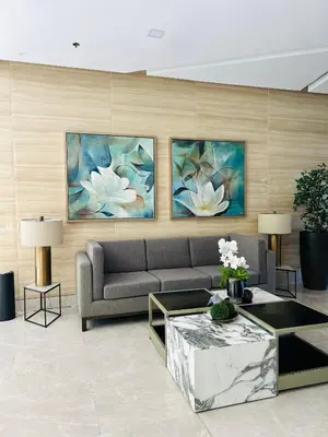 a living room with a couch and paintings on the wall at Casa Bella Retreat in Manila