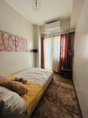 a bedroom with a large bed and a window at Casa Bella Retreat in Manila