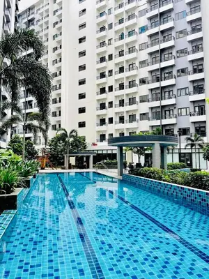 a large blue swimming pool in front of a large building at Casa Bella Retreat in Manila