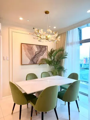 a dining room with a table and green chairs at Modern 4BR in Central BGC Walk to Shangrila and Ascot in Manila