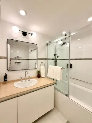 a bathroom with a sink and a shower at Modern 4BR in Central BGC Walk to Shangrila and Ascot in Manila