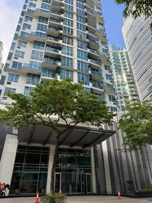 a tall building with a tree in front of it at Modern 4BR in Central BGC Walk to Shangrila and Ascot in Manila