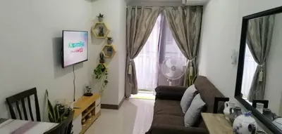 a living room with a couch and a window at Vienna's Accomodation in Manila