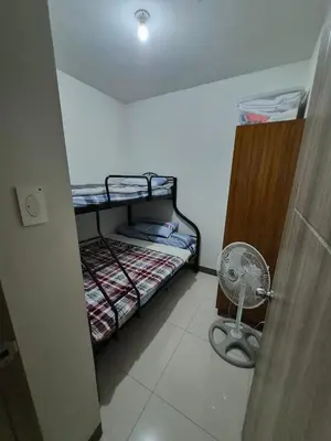 a small room with a bunk bed and a fan at Vienna's Accomodation in Manila