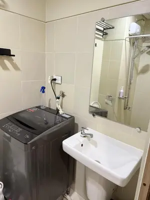 a bathroom with a sink and a mirror at S residence tower 3 Friendship family hotel in Manila
