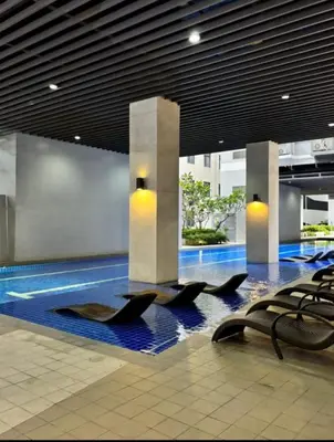 a lobby with black chairs in a building at S residence tower 3 Friendship family hotel in Manila