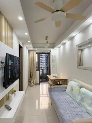 a living room with a bed and a table at S residence tower 3 Friendship family hotel in Manila