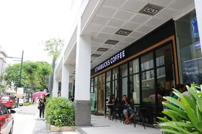 a store front with people sitting outside of it at Sarasota Residential Resort Manila in Manila