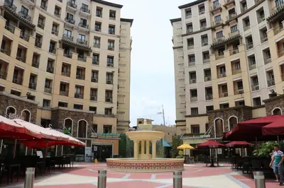 a fountain in the middle of a city with buildings at Sarasota Residential Resort Manila in Manila