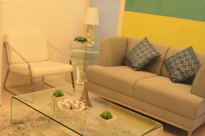 a living room with a couch and a chair at Touristation @ Crowne Bay Tower in Manila