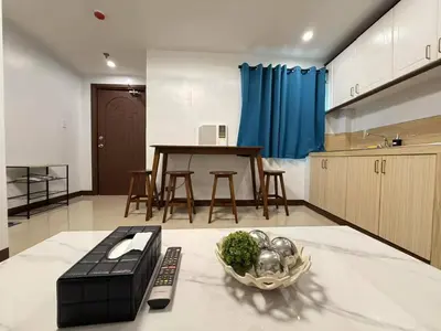 a kitchen with a table and a bowl of vegetables at Touristation @ Crowne Bay Tower in Manila