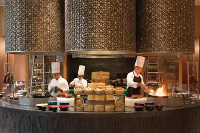 a group of chefs preparing food in a kitchen at Shangri-La The Fort, Manila in Manila