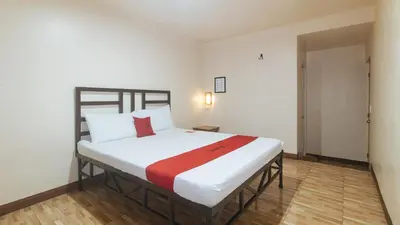 a bedroom with a large bed in a room at RedDoorz at Elegance Guest House near NAIA T3 in Manila