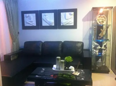 a living room with a couch and a table at Sea Residences - Rheiyn in Manila