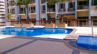 a swimming pool in front of a building at One Palm Tree Villa CC9N in Manila