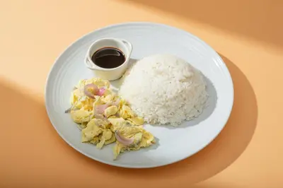 a plate of food with rice and a cup of coffee at Hotel Juliano in Manila