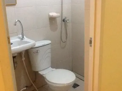 a bathroom with a shower and a toilet and a sink at AAM Transient and Guest House in Manila