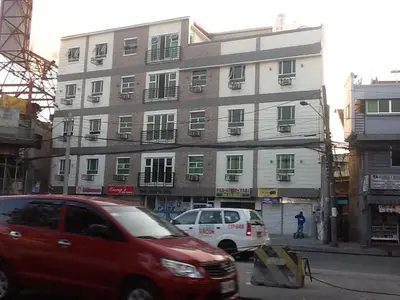 a red van parked in front of a building at AAM Transient and Guest House in Manila