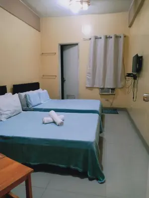 a bedroom with a bed with a stuffed animal on it at AAM Transient and Guest House in Manila