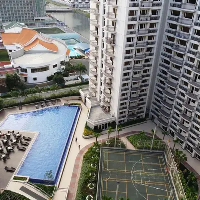 an overhead view of a pool in a city with tall buildings at Solemare Parksuites Condominium - Condo R Us in Manila