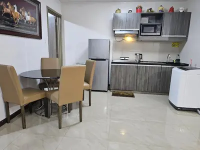 a kitchen and dining room with a table and chairs at Solemare Parksuites Condominium - Condo R Us in Manila