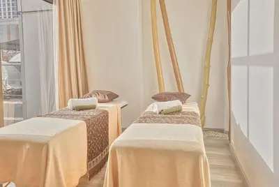 two beds in a room with a window at Holiday Inn & Suites Manila Galleria by IHG in Manila