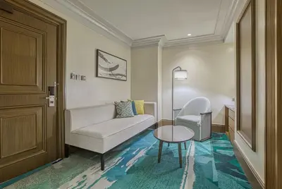 a living room with a couch and a table at Holiday Inn & Suites Manila Galleria by IHG in Manila