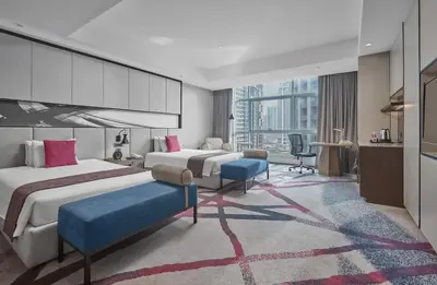 a hotel room with two beds and a desk at Crowne Plaza Manila Galleria by IHG in Manila