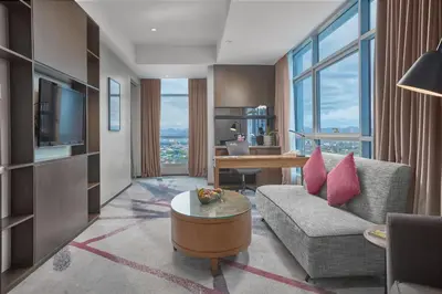 a living room with a couch and a table at Crowne Plaza Manila Galleria by IHG in Manila