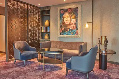a living room with a couch and two chairs at Crowne Plaza Manila Galleria by IHG in Manila