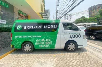a green and white car parked on a street at Go Hotels Manila Airport Road in Manila