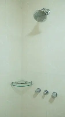 a shower with a shower head in a bathroom at Avant Serviced Suites - Personal Concierge in Manila
