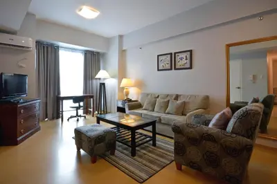 a living room with a couch and a table at Avant Serviced Suites - Personal Concierge in Manila