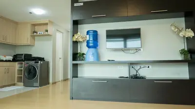 a kitchen with a washing machine and a blue bottle on the wall at Avant Serviced Suites - Personal Concierge in Manila