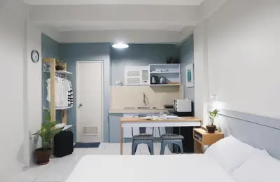 a small kitchen with a table and a desk in a room at Dragonfly Apartments and Transient House in Bacoor